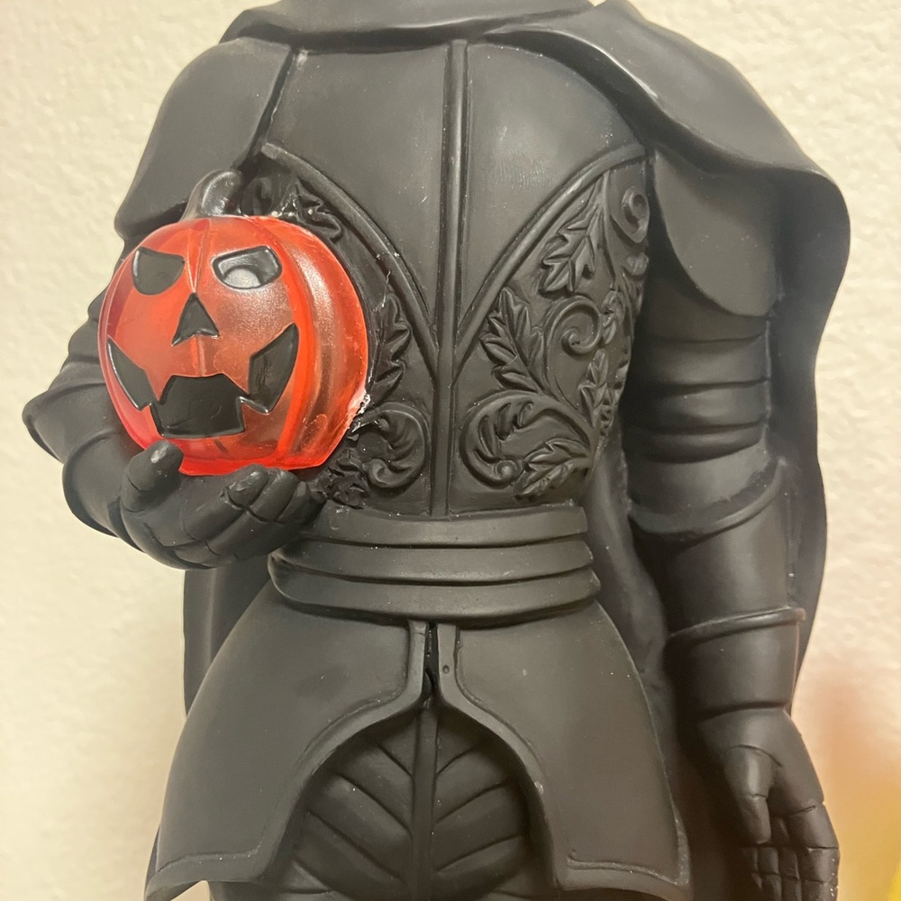 Black Cloaked Figure with Red Jack-o'-Lantern